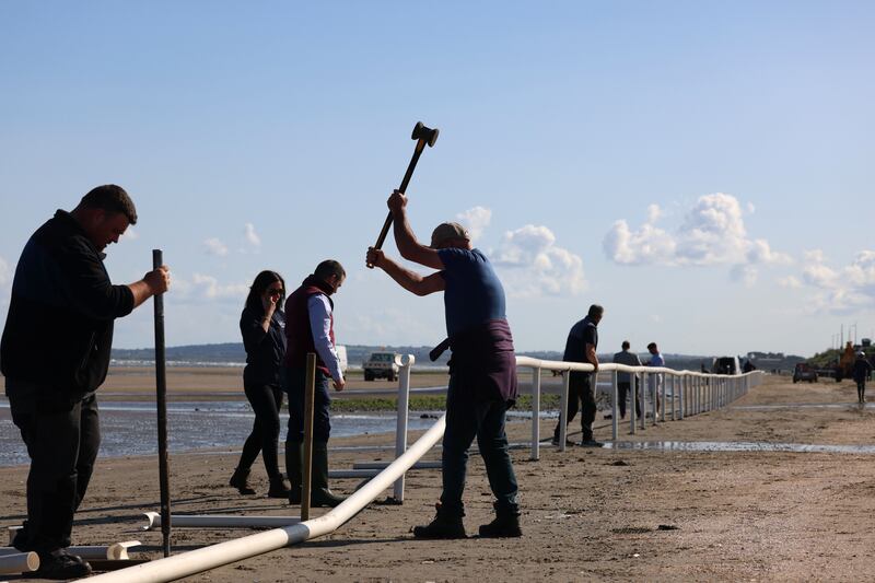 Workers set up the boundaries for the races. Photograph: Dara Mac Dónaill/The Irish Times