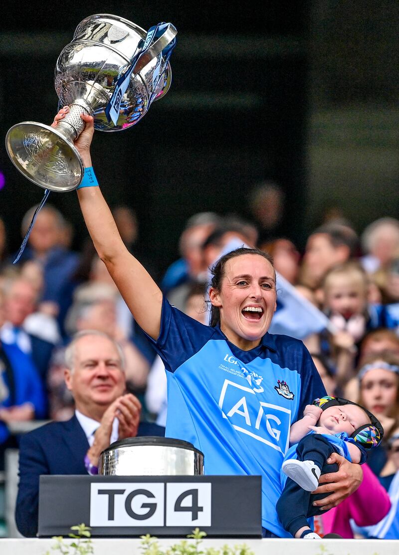 Hannah Tyrrell of Dublin holds her seven week old daughter Aoife as she lifts the Brendan Martin Cup after the 2023 TG4 LGFA All-Ireland Senior Championship Final match against Kerry. Photograph: Seb Daly/Sportsfile