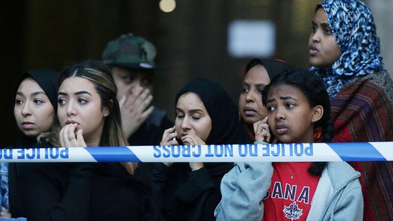 Local residents watch as Grenfell Tower is engulfed by fire in west London.  Photograph: Daniel Leal-Olivias/AFP/Getty Images