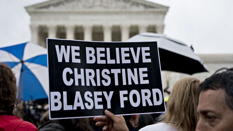 A demonstrator holds a “We Believe Christine Blasey Ford” sign outside the US supreme court in Washington on Monday. Photograph:  Andrew Harrer/Bloomberg