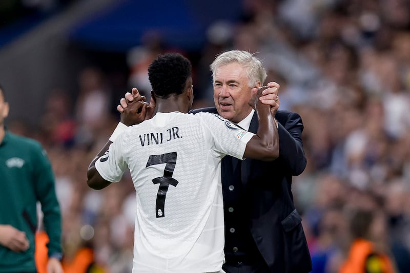 Vinícius Junior celebrates with Carlo Ancelotti during Real Madrid's 5-2 win over Borussia Dortmund on Tuesday, when the Brazilian scored a hat-trick. Photograph: Manu Reino/DeFodi Images via Getty Images