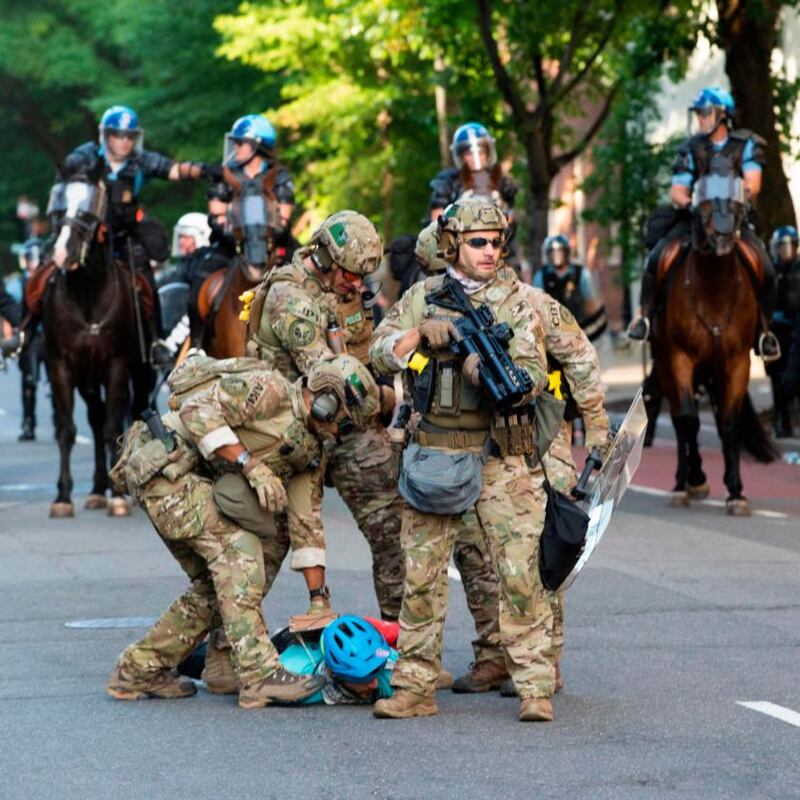 Military police officers restrain a protester near the White House on Monday. Photograph: Roberto Schmidt/AFP/Getty