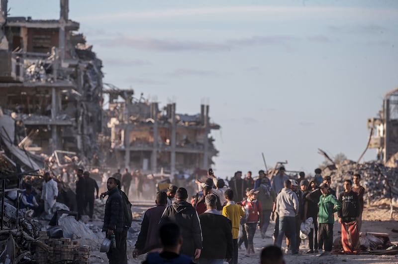 Internally displaced Palestinians walk along a street among the rubble of destroyed buildings in Rafah, southern Gaza Strip. Photograph: Mohammed Saber