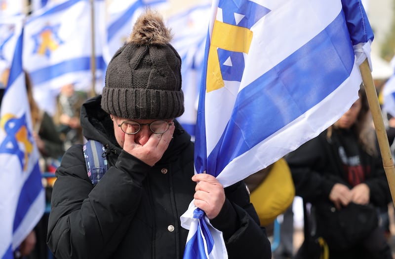 A woman reacts as people gather in Tel Aviv ahead of the release of the bodies of four Israeli hostages held in Gaza. Photograph: Abir Sultan/EPA