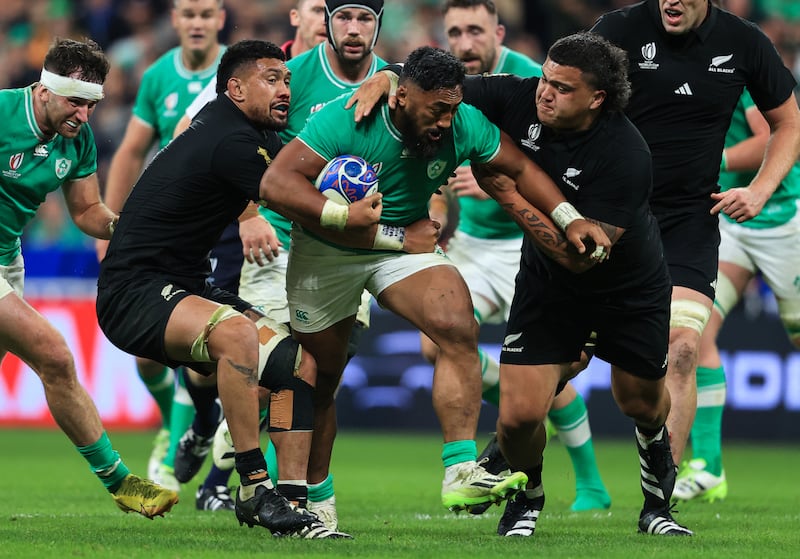 Ireland’s Bundee Aki is tackled by Ardie Savea and Tamaiti Williams of New Zealand in the 2023 Rugby World Cup quarter-final. Photograph: Dan Sheridan/Inpho