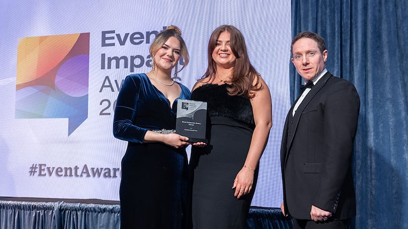 John Carty, awards judge, presents the best corporate event venue award to Laura Neill and Saoirse McDermott, Guinness Storehouse