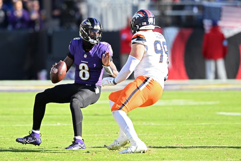 Lamar Jackson (left) of the Baltimore Ravens is pressured by the Denver Broncos' Zach Allen. Photograph: Greg Fiume/Getty Images