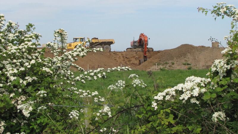 Motorway on water meadows: digger excavating a new section of the Belfast-Derry route beside Lough Beg. Photograph: Paddy Woodworth