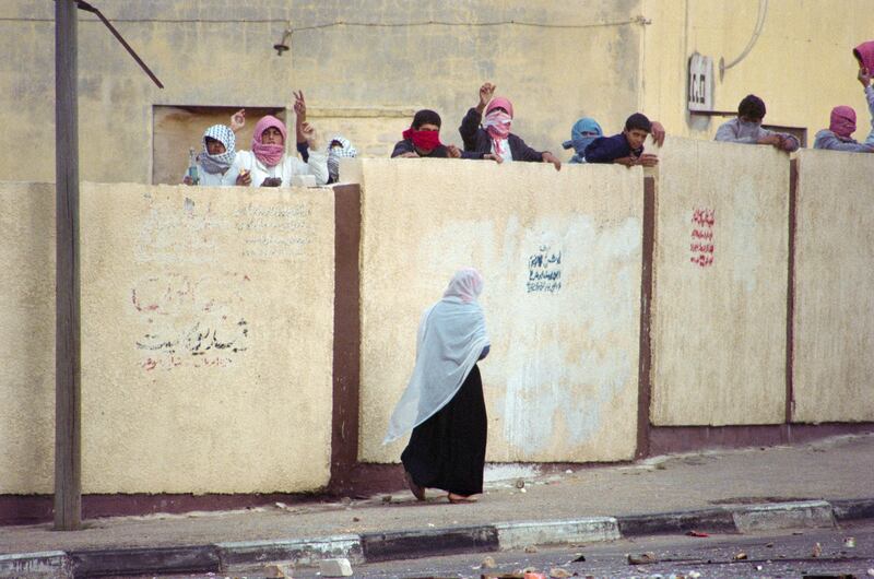 A woman walks past Palestinian during the Intifada in 1987. Photograph: Sven Nackstrand/AFP via Getty Images