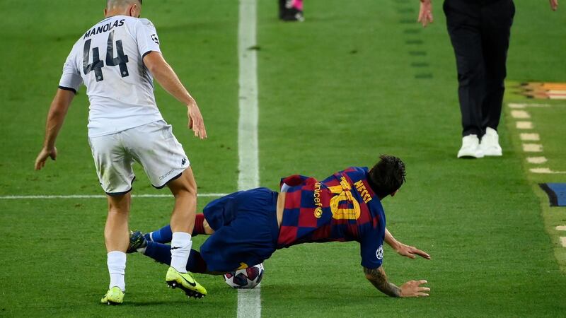 Kostas Manolas tackles Lionel Messi during Napoli’s defeat to Barcelona. Photograph: Lluis Gene/Getty/AFP