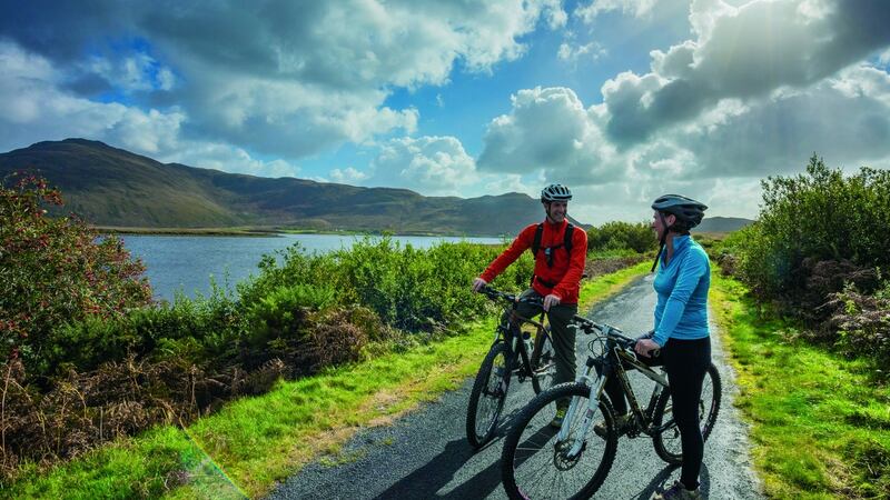 Cyclists on the Great Western Greenway, above Blacksod Bay.