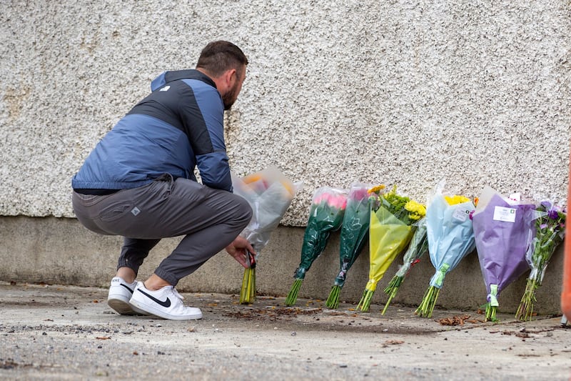 A man lays flowers near to the scene of the crash in Clonmel. Photograph: Damien Storan/PA Wire