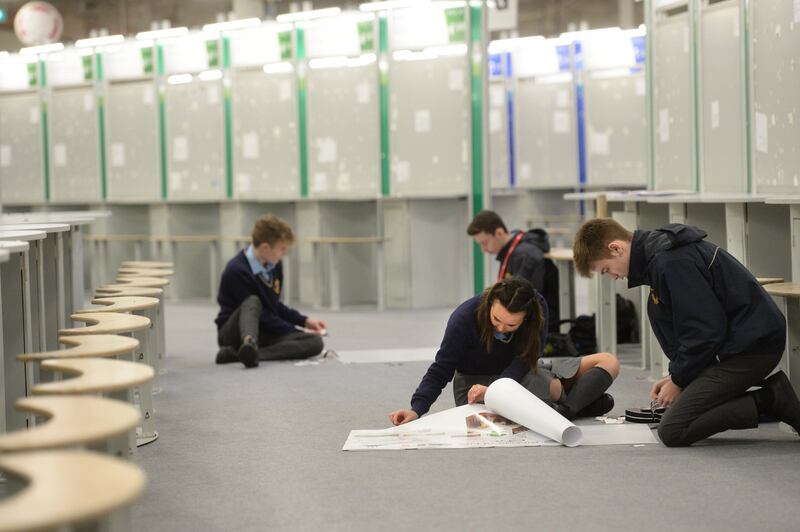 Students setting up at their displays  in the RDS Dublin before the exhibition’s opening Photograph: Dara Mac Dónaill/The Irish Times