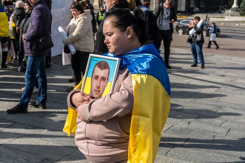 Svitlana Makovoz holds a photo of her husband, Andriy, at a protest to bring attention to soldiers who are missing in action, at Independence Square in Ukraine’s capital of Kyiv, on October 16th. Photograph: Brendan Hoffman/New York Times
                      