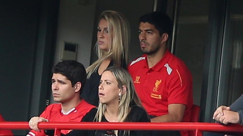 Luis Suarez of Liverpool watches his last match suspended from an executive box at Anfield. Photograph:  Clive Brunskill/Getty Images