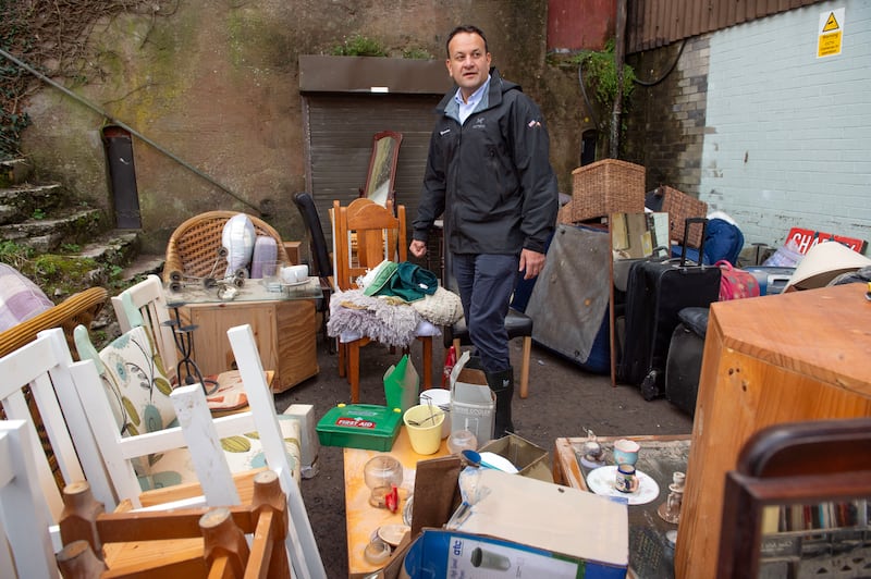 Leo Varadkar with damaged furniture caused by flooding at a charity shop in the town. Photograph: Michael Mac Sweeney/Provision