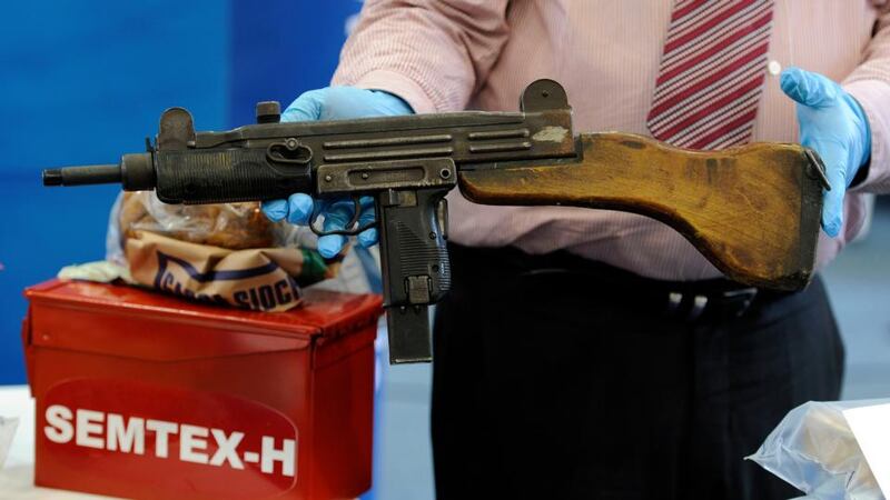 A garda holds an Uzi submachine gun that was seized  in a Garda operation at Cloghran, Co Dublin recently.Photograph: Dave Meehan/The Irish Times