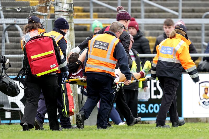 Galway’s Damien Comer is departs the field on a stretcher after landing awkwardly following an aerial duel. Photograph: Laszlo Geczo/Inpho