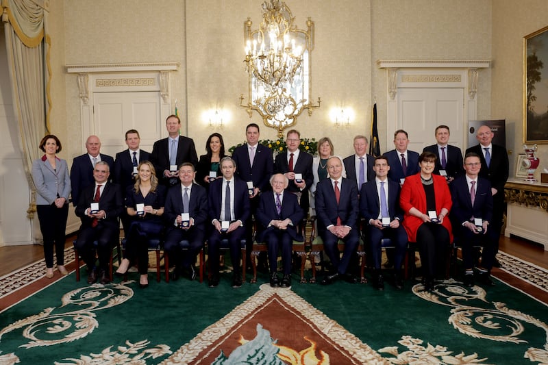 President Michael D Higgins with Taoiseach Micheál Martin, Tánaiste Simon Harris and other new Cabinet members as they receive their seals of office. Photograph: Maxwell's/PA Wire