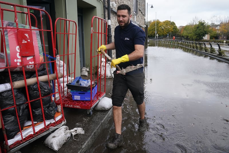 Ross Campbell, sales assistant at Vivo, clears out a damaged property in Newry Town. Photograph: Brian Lawless/PA