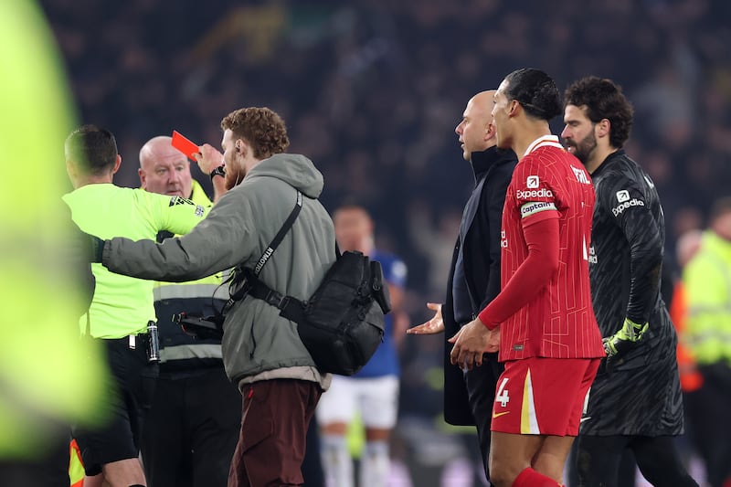 Arne Slot, manager of Liverpool, is shown a red card by referee Michael Oliver at the end of the Premier League match between Everton and Liverpool. Photograph: Carl Recine/Getty