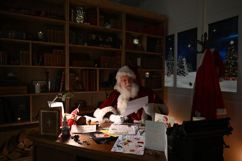 Santa Claus reads and answers Christmas letters. Photograph: Caroline Blumberg/EPA