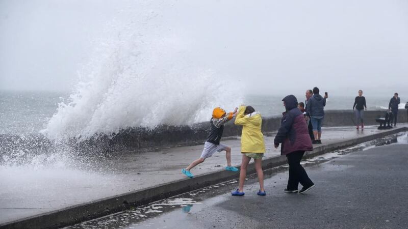 People are hit by waves on the Front Strand in Youghal, Co Cork on Wednesday. Photograph: Niall Carson/PA Wire