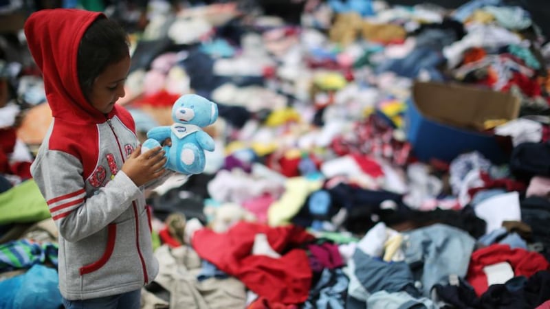 A young Syrian girl finds a toy among clothes donated by the people of Hungary at Keleti station. Photograph: Christopher Furlong/Getty Images