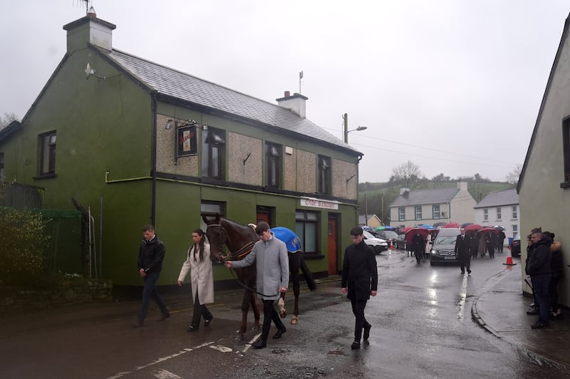 The hearse carrying the coffin of Michael O'Sullivan is led by a horse on a procession away from the grounds following the funeral at St John the Baptist Church, Glantane, Co Cork. Photograph: Brian Lawless/PA Wire