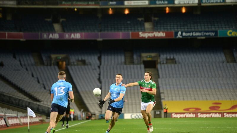 Con O’Callaghan passes to Paddy Small as Oisín Mullin tracks him during the All-Ireland SFC final between Mayo and Dublin. Photo: Dara Mac Donaill/The Irish Times