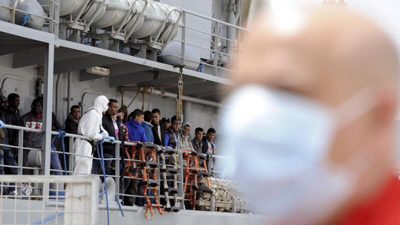 Migrants wait to disembark from the Irish navy ship LE Eithne as they arrive in the Sicilian harbour of Palermo, Italy, May 30, 2015. Photograph: Guglielmo Mangiapane/Reuters