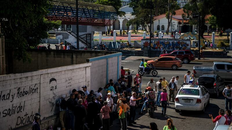 People visit a mural that pays tribute to Alixon  Pisani, near where he was killed while participating in an anti-government street protest, in Catia, Caracas. Photograph: Meridith Kohut/The New York Times