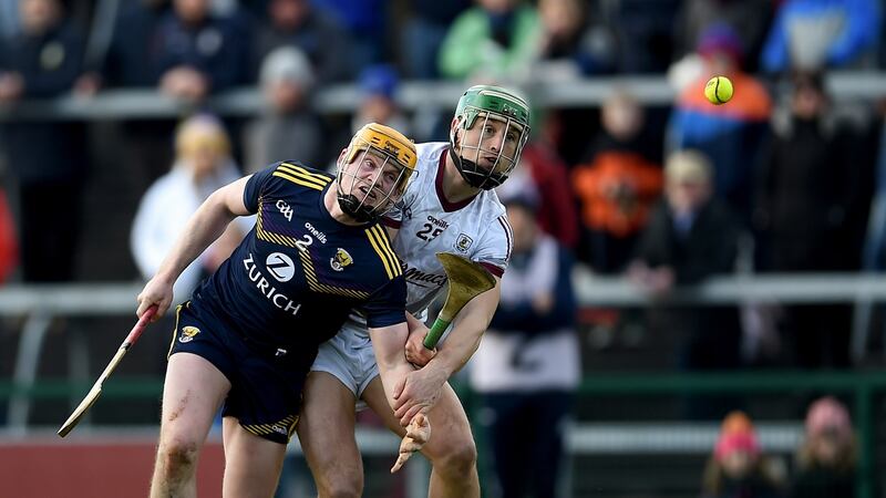 Wexford’s Simon Donohoe and  Niall Burke of Galway in action during the game in Salthill. Photograph: Tommy Grealy/Inpho