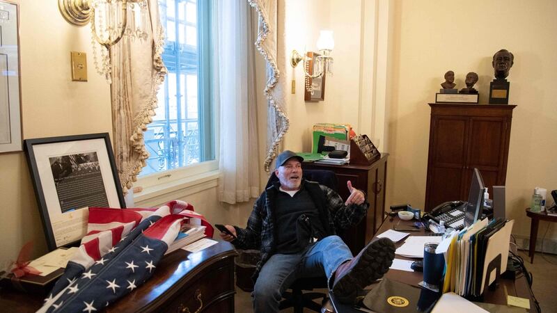 Richard Barnett, a supporter of US President Donald Trump sits inside the office of US Speaker of the House Nancy Pelosi. Photograph: Saul Loeb/AFP via Getty