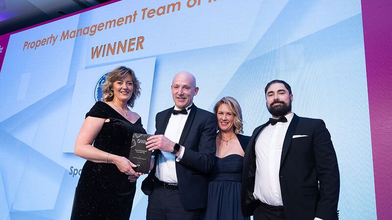 Ronan McDonnell, operations director at SOS Group, presents the Property Management Team of the Year award to WYSE Property Management team