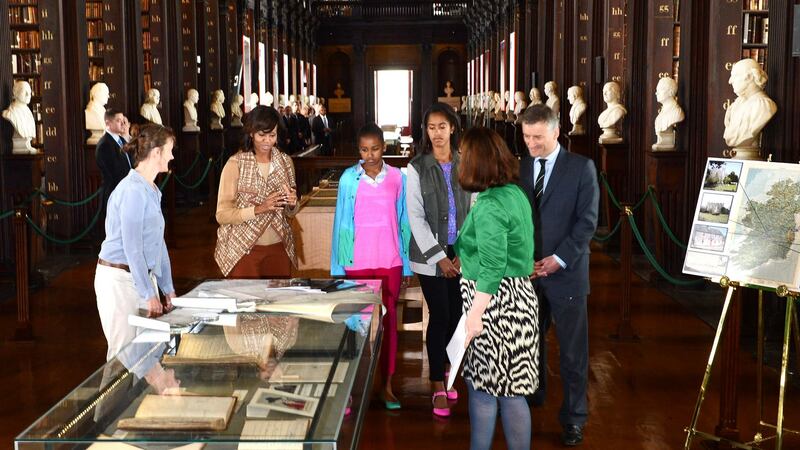 Former US First Lady Michelle Obama with her daughters, Sasha and Malia, on a visit to the Long Room at Trinity College in 2013 as part of a visit to view the Book of Kells. The popular attraction generates about €12 million net in revenue for Trinity each year. Photograph: Cyril Byrne