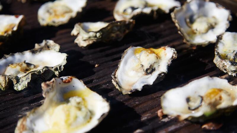 Cooking fresh oysters on the barbecue. Photograph: Mikkel Kallehauge/Mark & Bjerre Photography