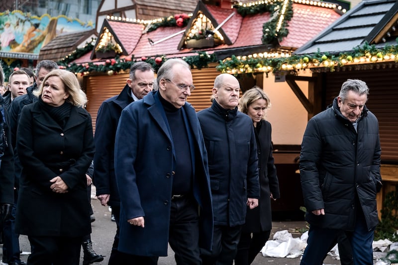 German chancellor Olaf Scholz (third from right) and regional elected officials at the scene in Magdeburg on Saturday. Photograph: Jesco Denzel/Bundesregierung via Getty Images