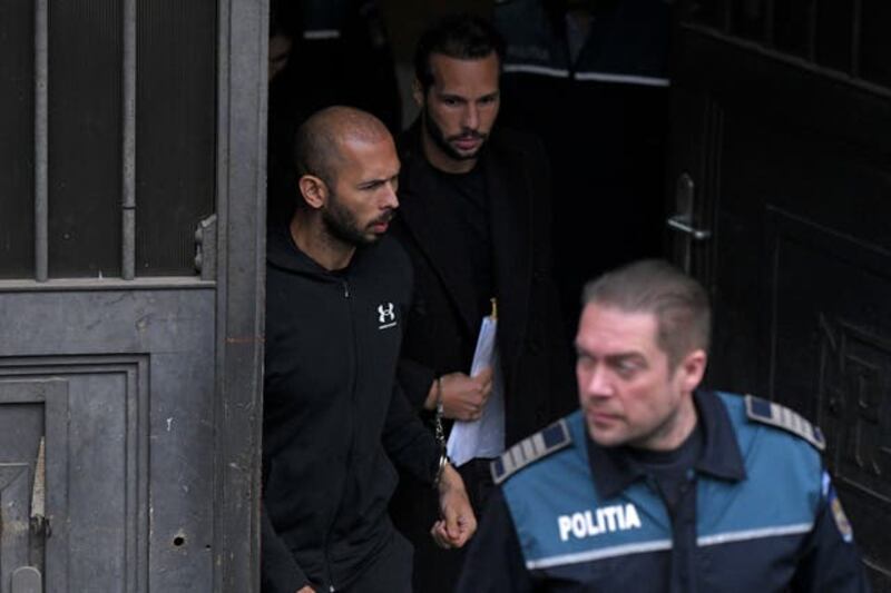 Andrew and Tristan Tate being escorted by Romanian police. Photograph: AP