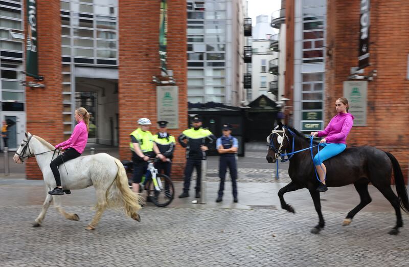 Gardaí and participants at the Smithfield Horse Fair in Dublin on Sunday. Photograph: Dara Mac Dónaill