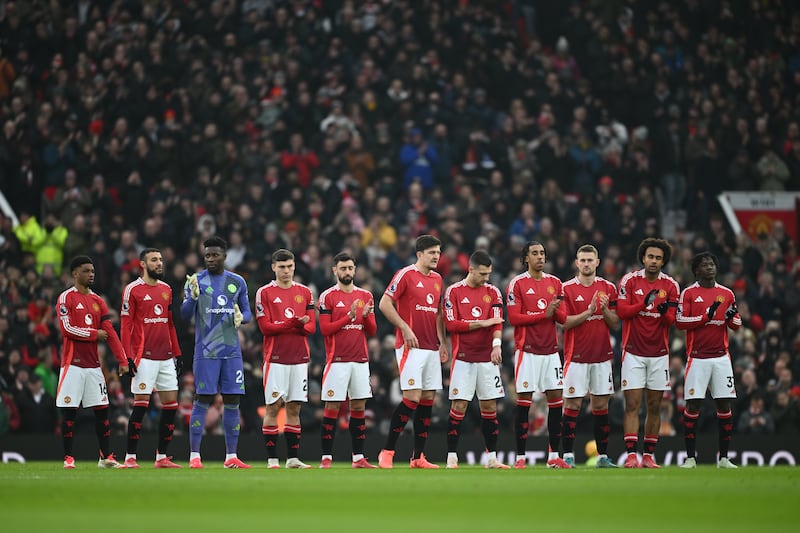 Manchester United players observe a minute silence in remembrance of Dennis Law ahead of the game. Photograph: Gareth Copley/Getty Images