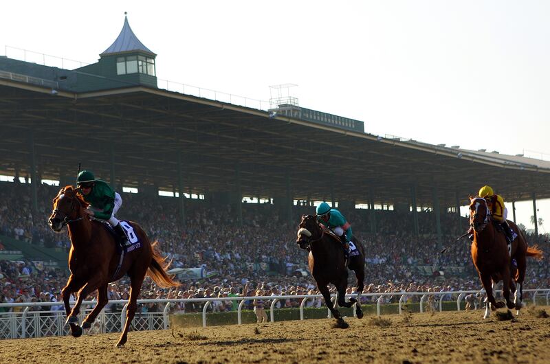 Jockey Lanfranco Dettori atop Raven's Pass crosses the finish line ahead of Mike Smith atop Tiago and Robby Albarado atop Curlin to win the Breeders' Cup Classic in Arcadia, California.  Photograph: Matthew Stockman/Getty Images