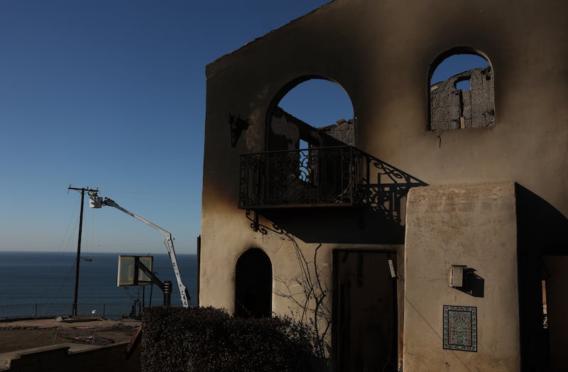 Utility crews repair electrical lines damaged by the Palisades fire on Sunday. Photograph:Justin Sullivan/Getty 