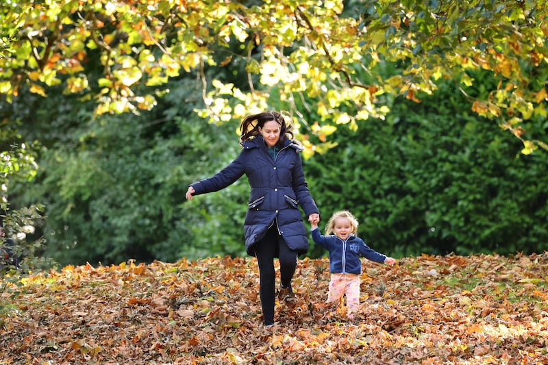 Zara Winterlich and her daughter Nicole enjoying the autumn leaves in St Stephen's Green, Dublin. Photograph: Dara Mac Dónaill