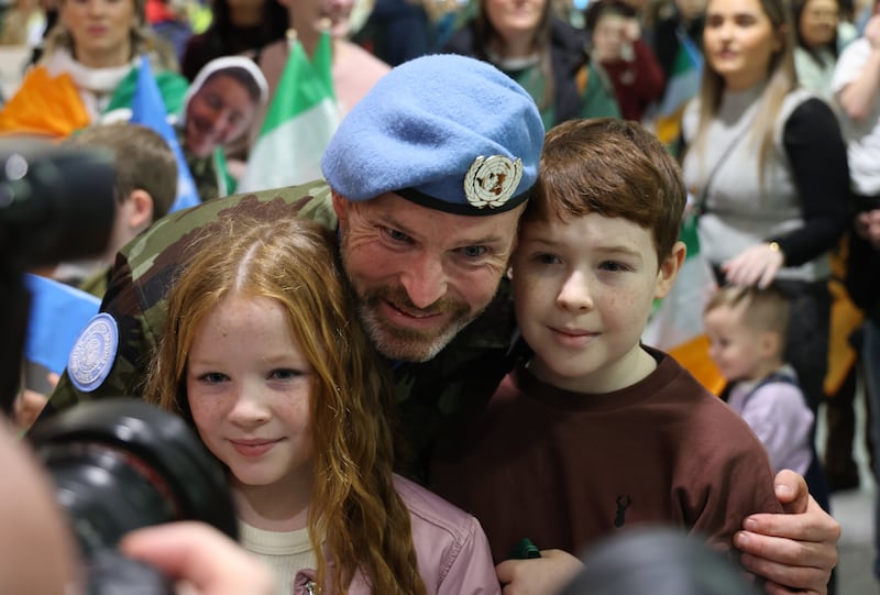  Sgt. Seamus O'Donnacha is hugged by his kids Jake (10) and Ella (9) at Dublin Airport. Photo: Bryan O’Brien