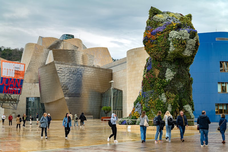 The Guggenheim Bilbao museum, with a floral sculpture by Jeff Koons. Photograph: Emilio Parra Doiztua/The New York Times