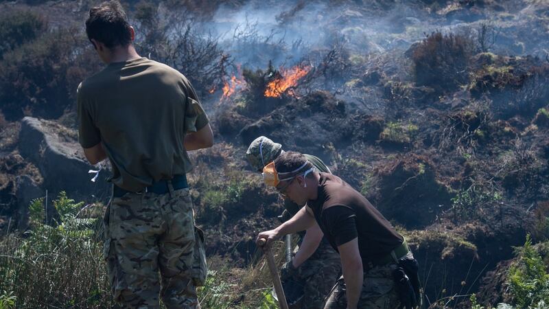 A  British Ministry of Defence (MOD) handout photograph  shows British Army soldiers of 4 Scots help dig ditches and ‘breaks’ to maintain the fires as they continue to support Great Manchester Fire and Rescue Service with the Saddleworth Moor fire, north west England, Britain, 29 June 2018. Photograph: Sgt  Donald Todd via EPA.