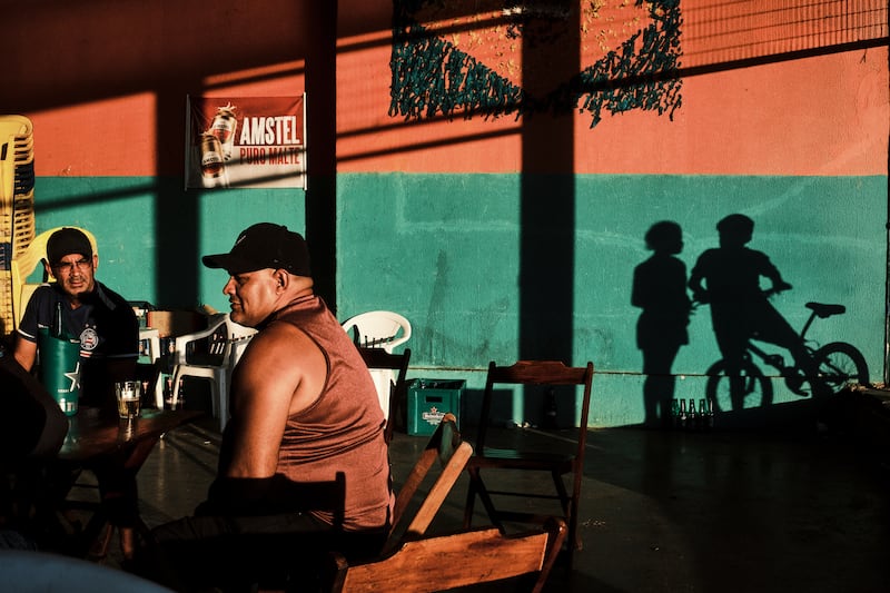 Men drink beer in a public market in Cruzeiro neighbourhood in Brasília. Photograph: Gustavo Minas