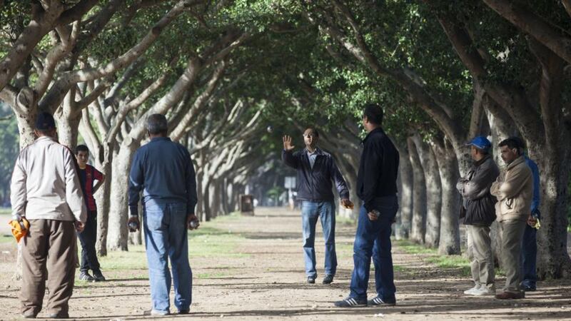 Men play pétanque under a canopy of trees at the Parc de La Ligue Arabe. Photograph: Ben Sklar for The New York Times