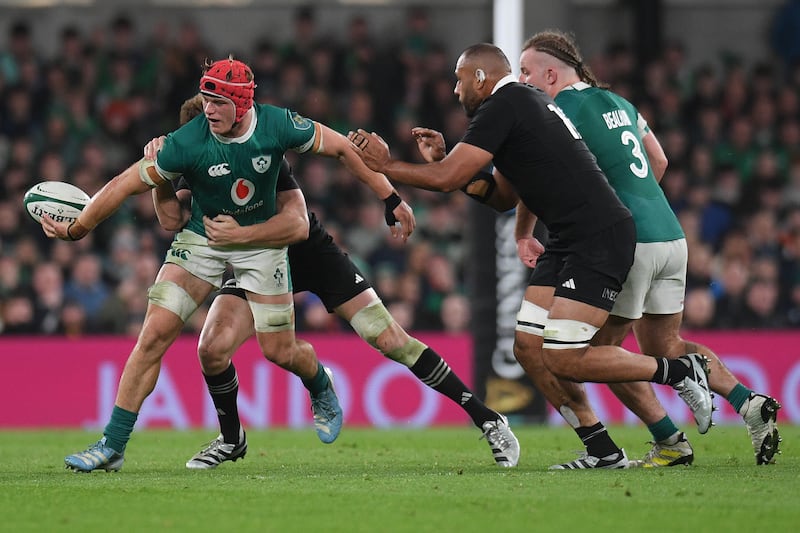 Josh van der Flier offloads during the Autumn Nations Series match against New Zealand at the Aviva Stadium. Photograph: Charles McQuillan/Getty Images